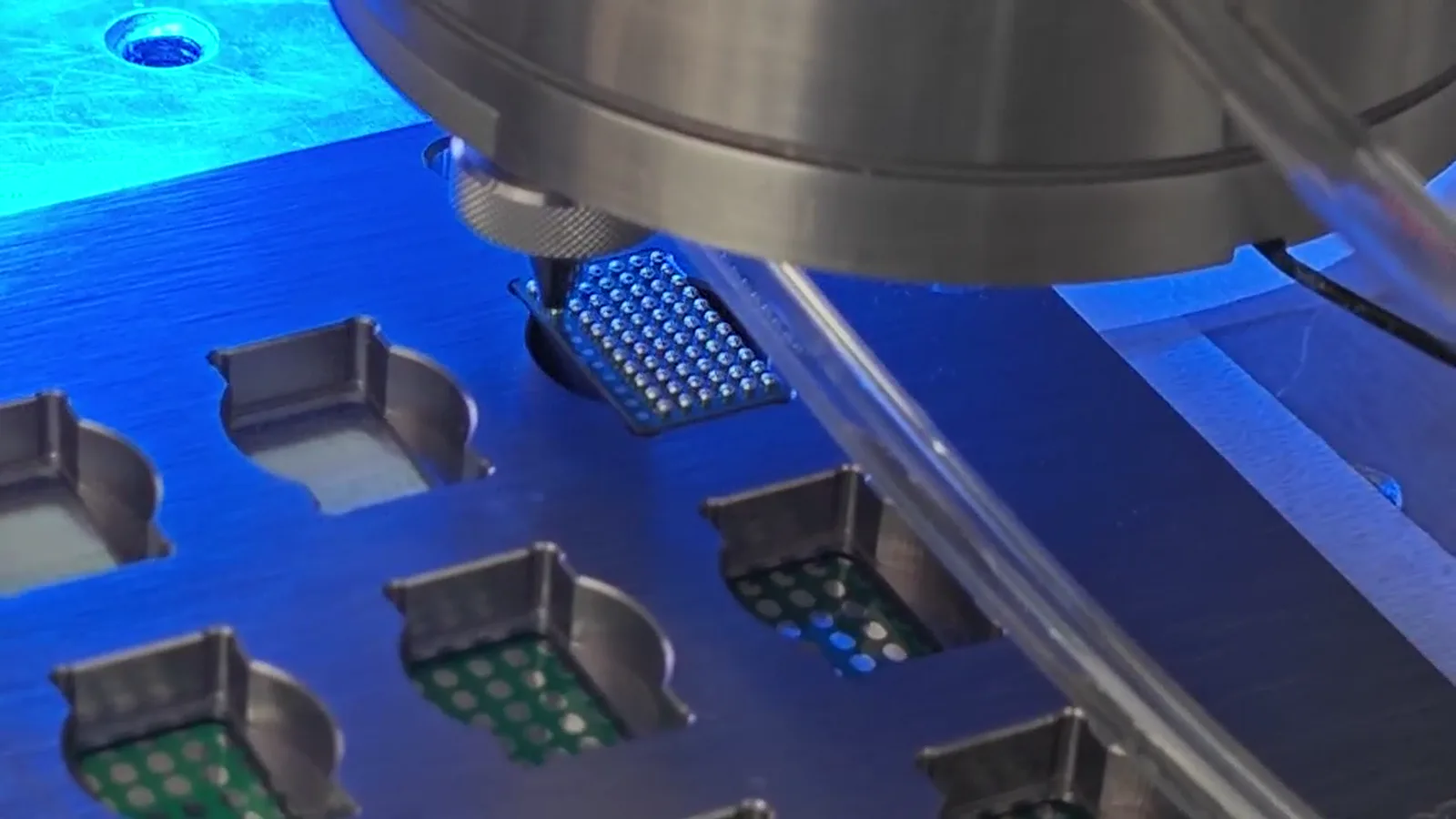 Fixture-supported electronic test positions during a solder ball jetting process