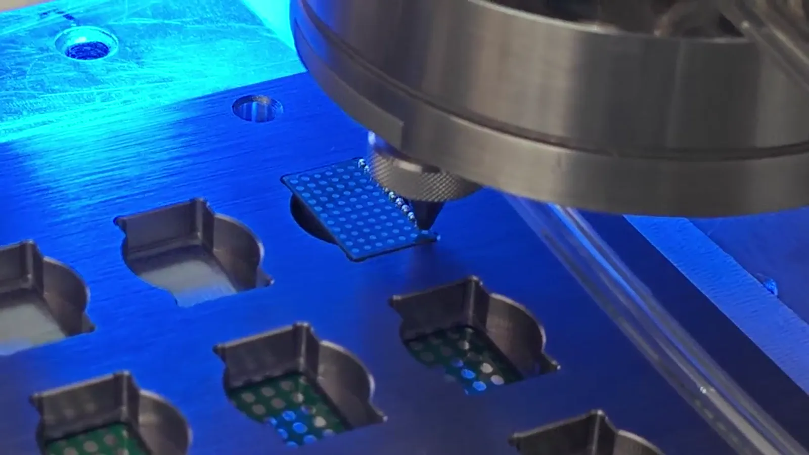 Laser solder ball jetting head above a supported electronic workpiece